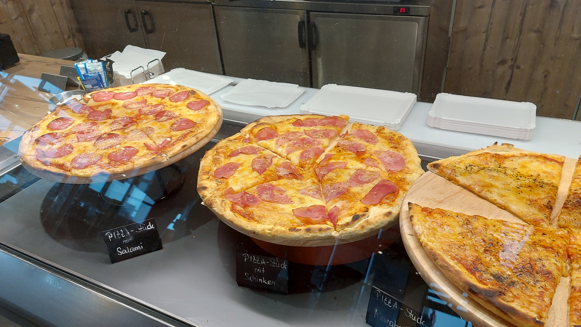 Drei Pizzen in der Theke der Brotzeithütte am Autohof Bergler